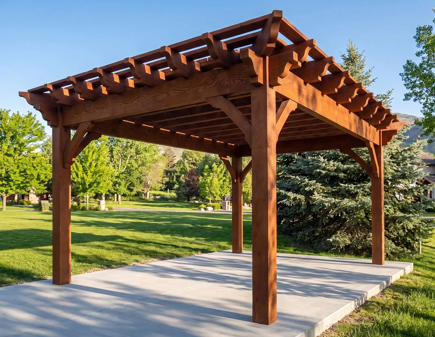 Wood pergola standing over a poured concrete slab in a backyard lawn